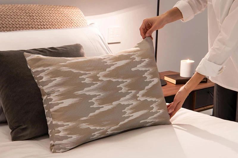 Hands arranging a pillow