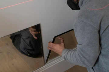 Technical team assembling a mirror